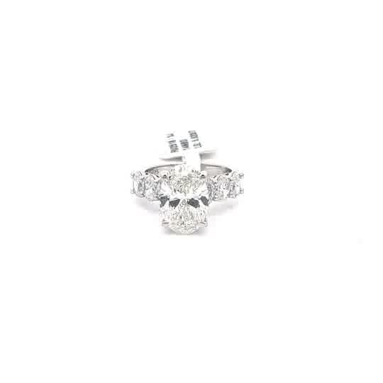 Multistone Ring with Oval Cut Diamond. :62cts