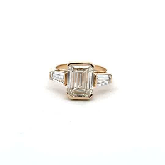 Emerald Cut Diamond Three-Stone Ring in Yellow Gold Bezel Setting