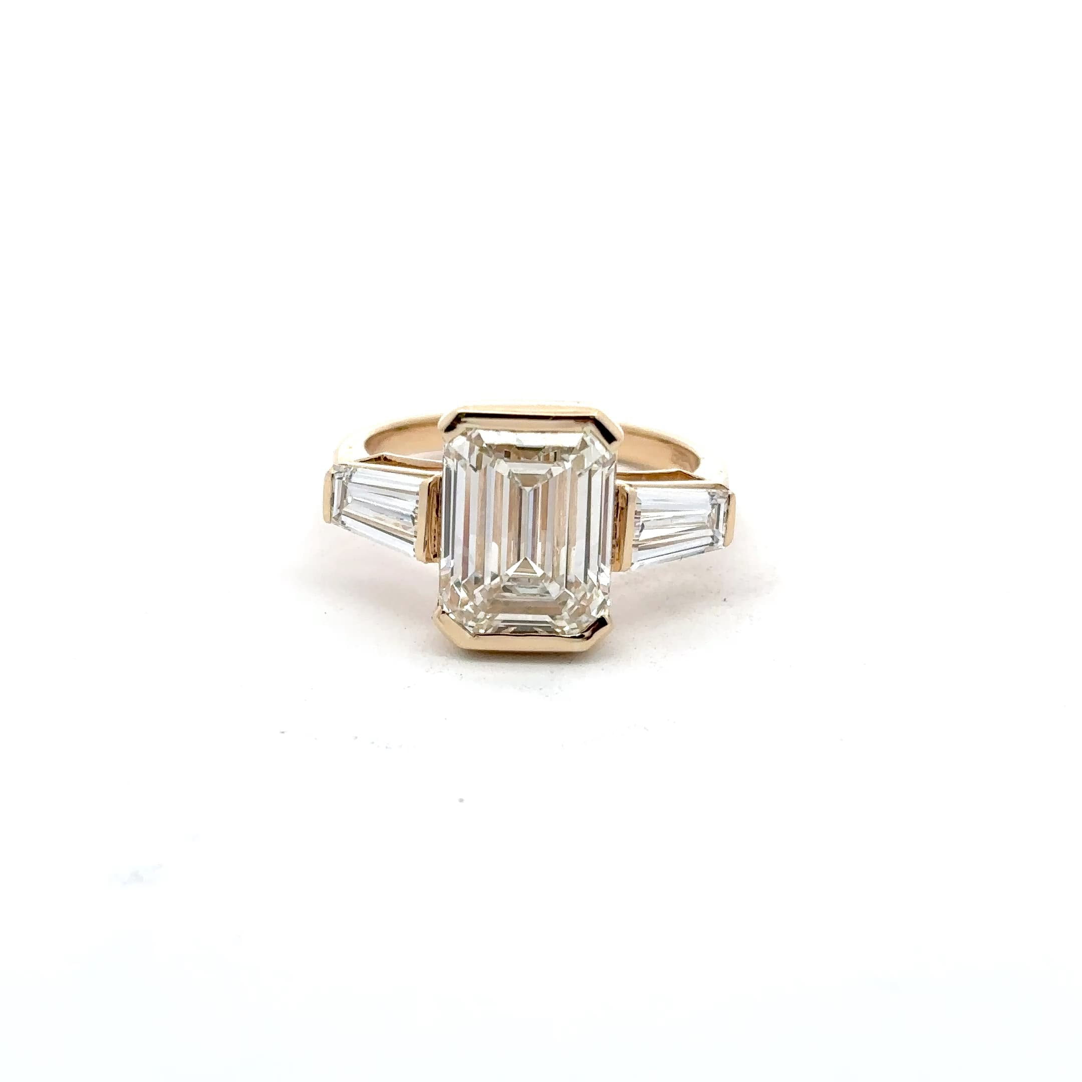 Emerald Cut Diamond Three-Stone Ring in Yellow Gold Bezel Setting 2