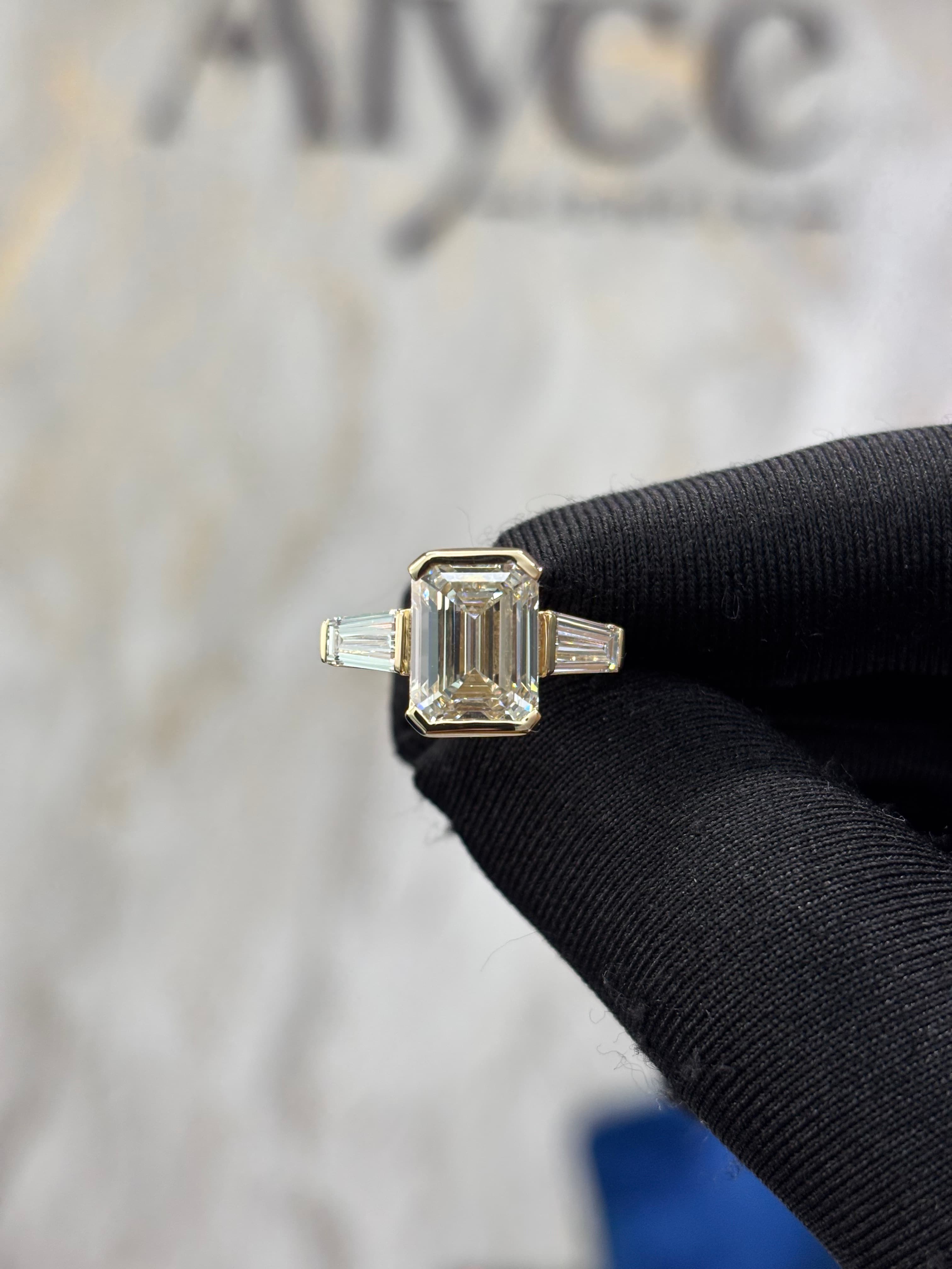 Emerald Cut Diamond Three-Stone Ring in Yellow Gold Bezel Setting 3