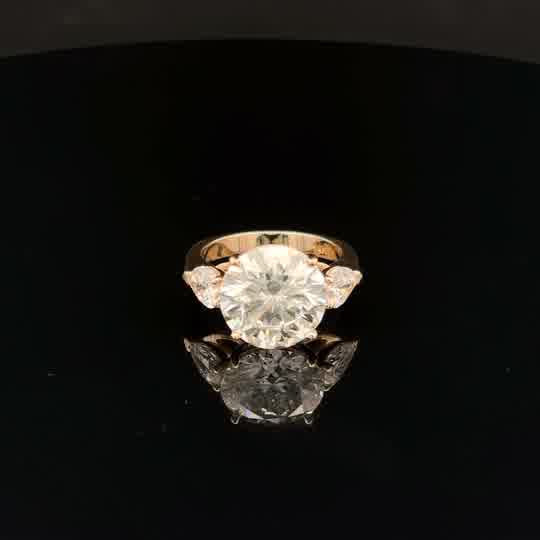 Three-Stone Round and Pear Diamond Ring in Yellow Gold