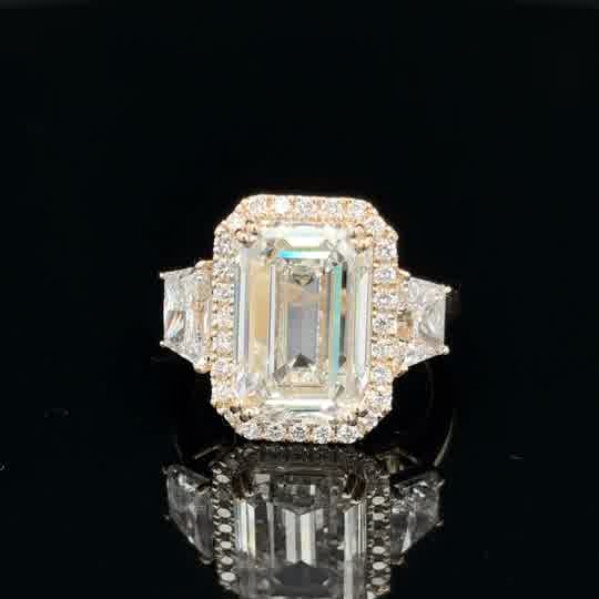 Emerald Cut Diamond Halo Three-Stone Ring in Yellow Gold